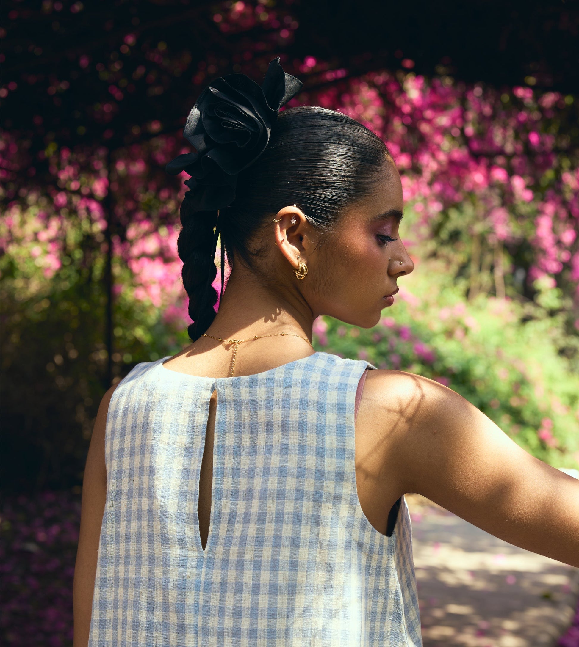 Sleeveless gingham kala cotton trapeze top with brass button closure, made from organic cotton.