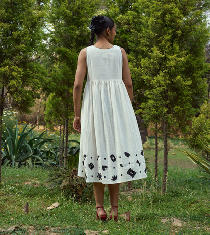 Sleeveless kala cotton midi dress with hand-stitched appliqué patterns and pockets, designed for versatile styling.