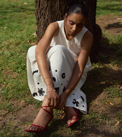 Sleeveless kala cotton midi dress with hand-stitched appliqué patterns and pockets, designed for versatile styling.