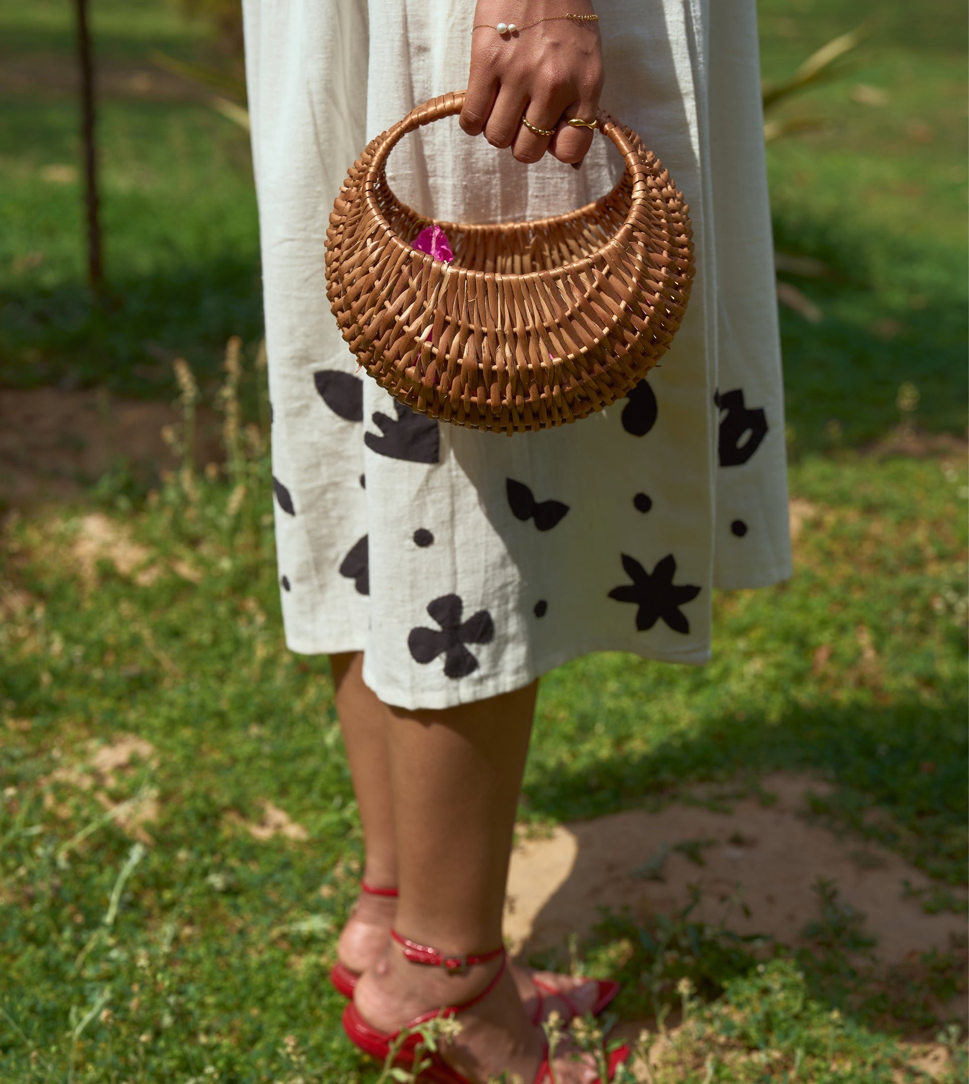 Sleeveless kala cotton midi dress with hand-stitched appliqué patterns and pockets, designed for versatile styling.